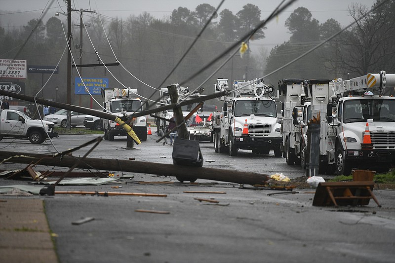 Crews work to repair power lines damaged overnight by a tornado in Hot Springs Village on Friday, March 15, 2024. (Arkansas Democrat-Gazette/Stephen Swofford)