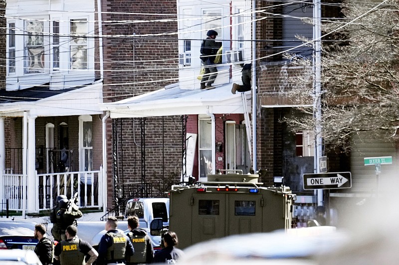 Police surround a home in Trenton, N.J., where a suspect barricaded himself inside on Saturday.
(AP/Matt Rourke)
