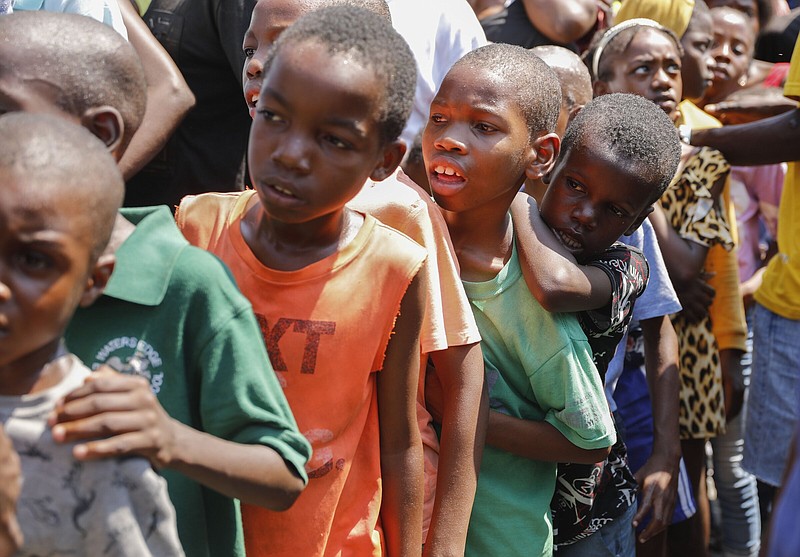 Children line up to receive a plate of food at a shelter for families displaced by gang violence in Port-au-Prince, Haiti, on Thursday.
(AP/Odelyn Joseph)