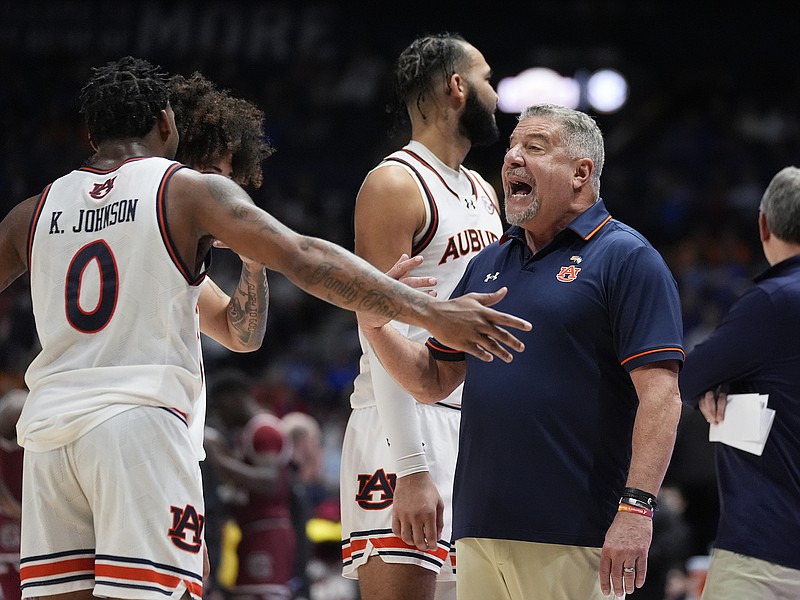 AP photo by John Bazemore / Auburn men's basketball coach Bruce Pearl talks to guard K.D. Johnson (0) during the team's quarterfinal game against South Carolina at the SEC tournament Friday in Nashville.