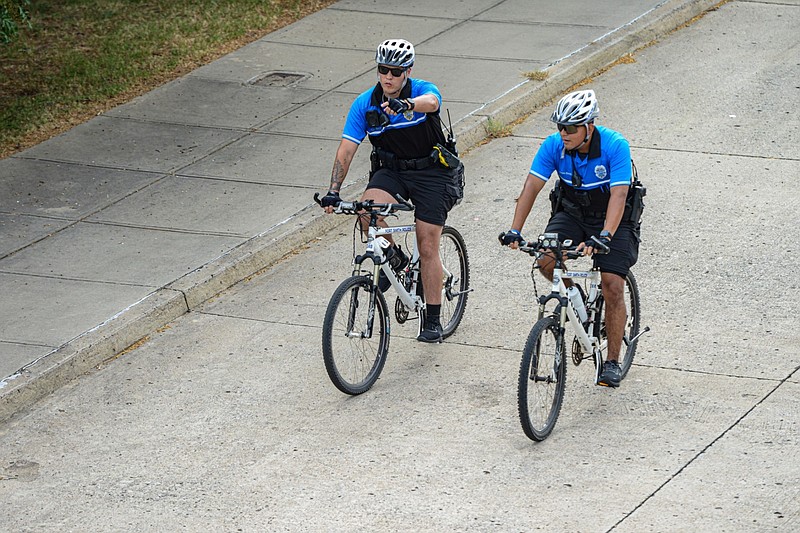 Alejandro Marin (left) and Manuel Valente-Sotelo with the Fort Smith Police Department’s Bicycle Patrol Unit ride in the city's downtown in this July 28, 2022 file photo. Russellville Police Department spokesperson Drew Reeves has said that the department would mobilize a bike patrol on April 8, 2024, during the solar eclipse. (NWA Democrat-Gazette/Hank Layton)