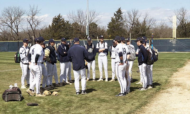 The Helias Crusaders meet after Saturday's 9-8 loss to the Marquette Mustangs at the American Legion Post 5 Sports Complex. (Tom Rackers/News Tribune)