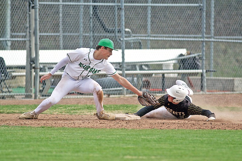 St. Elizabeth’s Blake Wobbe slides around tag by Blair Oaks’ Cole Ortbals to steal third base during Saturday afternoon’s game at Vivion Field. (Greg Jackson/News Tribune)