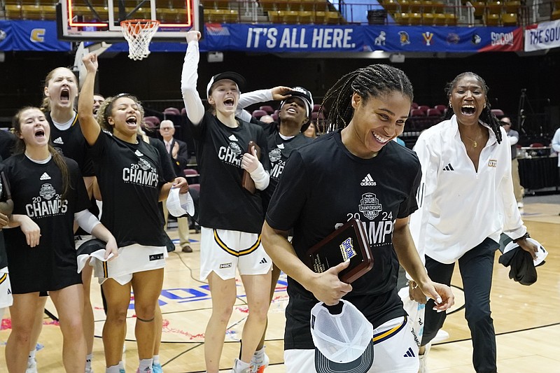 AP photo by Kathy Kmonicek / UTC guard Jada Guinn is cheered by teammates as she is presented the SoCon tournament MVP award on March 10 in Asheville, N.C.