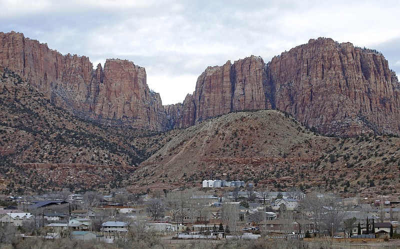 FILE - Hildale, Utah, is pictured sitting at the base of Red Rock Cliff mountains, with its sister city, Colorado City, Ariz., in the foreground on Dec. 16, 2014. On Tuesday, March 19, 2024, a businessman pleaded guilty to conspiring with the leader of an offshoot polygamous sect in the Colorado City-Hildale area to transport underage girls across state lines for sexual activity. The guilty plea by 53-year-old Moroni Johnson marked the first man to be convicted in what authorities say was a scheme to orchestrate sexual acts involving children. (AP Photo/Rick Bowmer, File)