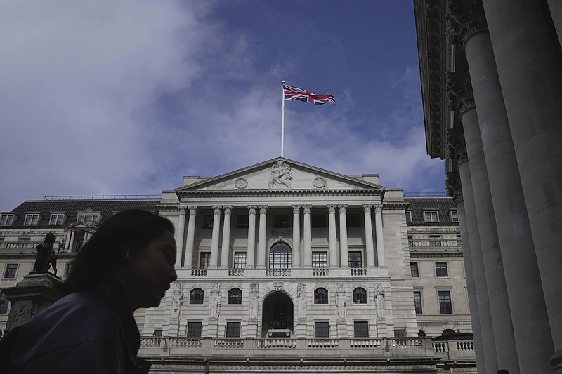 A woman walks past the Bank of England in London’s financial district in 2023.
(AP)