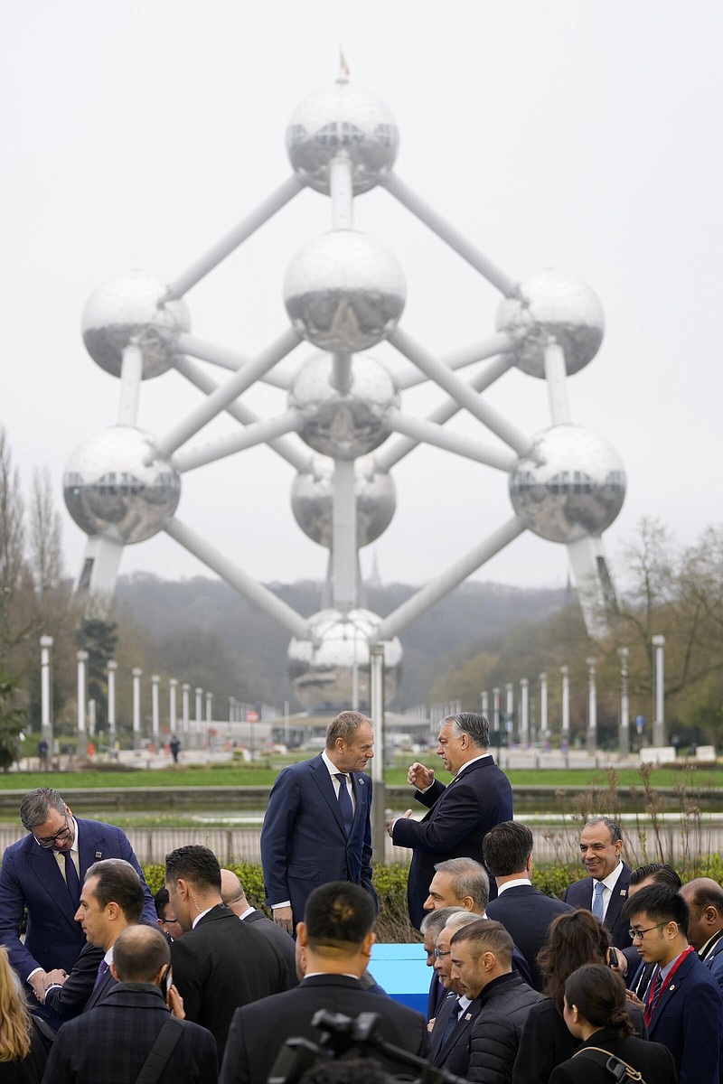 Hungary’s Prime Minister Viktor Orban (right) speaks with Poland’s Prime Minister Donald Tusk after posing for a group photo in front of the Atomium during a Nuclear Energy Summit at the Expo in Brussels on Thursday.
(AP/Virginia Mayo)