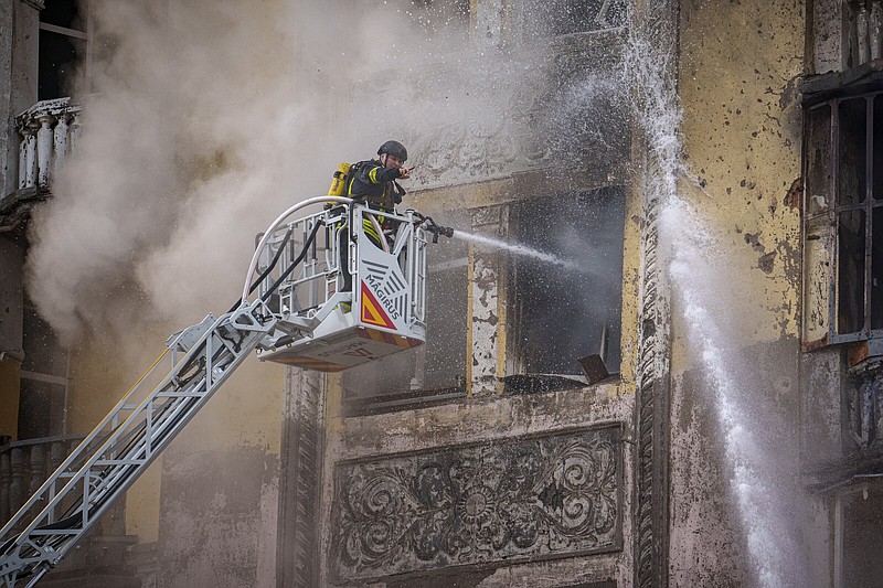 A firefighter gestures while spraying water inside a building at the site of a Russian attack in Kyiv, Ukraine, on Thursday. More photos at arkansasonline.com/ukrainemonth25/.
(AP/Vadim Ghirda)