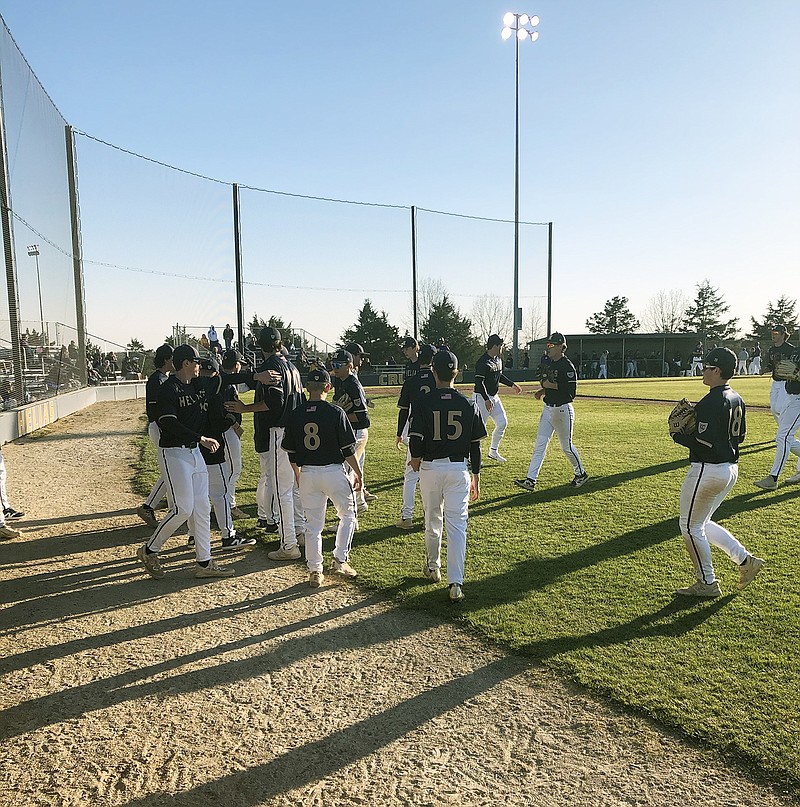 The Helias Crusaders meet outside the dugout after the top of the fourth inning in Wednesday's game against the Hickman Kewpies at the American Legion Post 5 Sports Complex. (Tom Rackers/News Tribune)