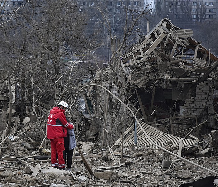 A medical worker comforts a woman at the site of a Russian air attack in Zaporizhzhia, Ukraine, on Friday. Russia’s aerial attack on the electric sector killed several people, plunged several cities into darkness and briefly cut off power to a nuclear plant.
(AP/Andriy Andriyenko)