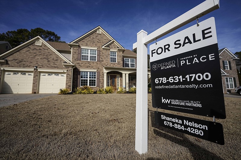 A sign announcing a home for sale is posted in February outside a residence in Aceworth, Ga., near Atlanta. The cost of hiring a real estate agent to buy or sell a home is poised to change along with decades-old rules that have helped determine broker commissions. (AP Photo/Mike Stewart)