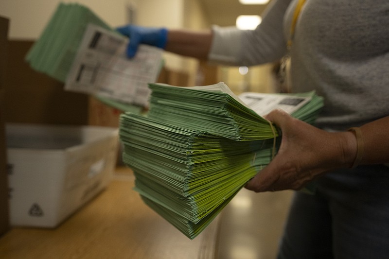 An election official sorts mail ballots at the Maricopa County Tabulation and Election Center in Phoenix, Tuesday, March 5, 2024. (AP Photo/Serkan Gurbuz)