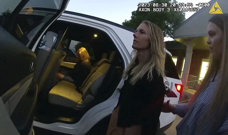 This image taken from body camera footage provided by Washington County Attorney's Office shows Jodi Hildebrandt, left, and Ruby Franke, center, being arrested on child abuse charges on Aug. 30, 2023, in Ivins, Utah. The twelve-year-old son of Franke, a Utah mother of six who gave parenting advice to millions via a once-popular a YouTube channel, had escaped through a window and approached several nearby homes until someone answered the door, according to documents released Friday. (Washington County Attorney's Office via AP)