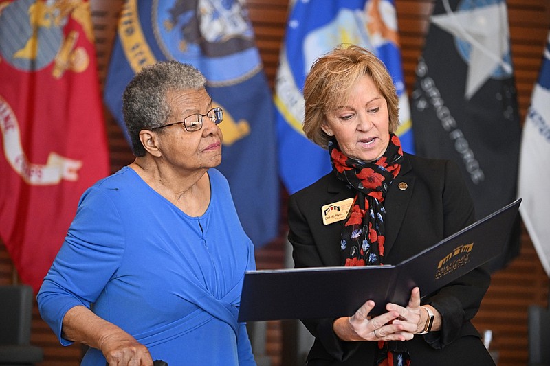 Phillis Wilson (right), a retired chief warrant officer 5 and the president of the Arlington, Va.-based Military Women’s Memorial, presents Elizabeth Eckford (left), one of the Little Rock Nine and a Women’s Army Corps veteran, with a Living Legend proclamation on Saturday, March 23, 2024 at the Clinton Presidential Center in Little Rock. (Arkansas Democrat-Gazette/Staci Vandagriff)