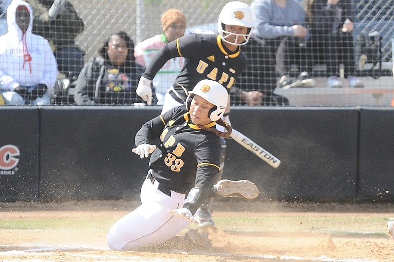 Shalin Charles (foreground), a senior on the University of Arkansas at Pine Bluff's softball team, slides home during the first inning against Alcorn State at the Torii Hunter Softball Complex in Pine Bluff on Saturday, March 23, 2024. (Special to the Commercial/William Harvey)
