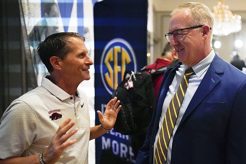 In this Oct. 18, 2023, file photo, SEC commissioner Greg Sankey (right) talks with Arkansas coach Eric Musselman at Southeastern Conference Media Days in Birmingham. Ala. (Associated Press)