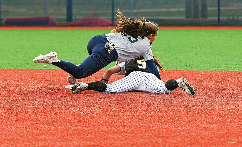 Emporia State’s Emma Furnish slides safely into second base under the falling Lincoln shortstop Gabby Newman in the first inning of Friday’s opening game of an MIAA doubleheader at LU Softball Field. (Julie Smith/News Tribune)