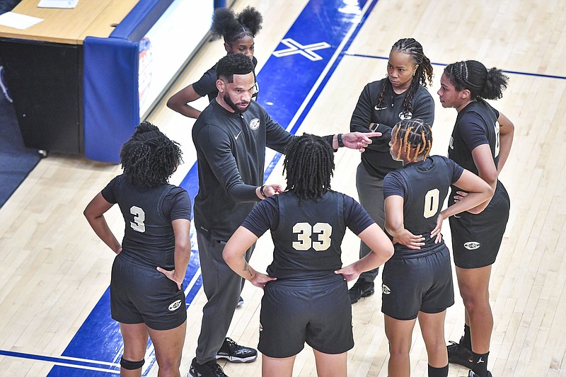 Little Rock Central head coach Marlon Williams (center) huddles with his team, Tuesday, Dec. 19, 2023, during the second quarter of the Greenwood Lady Bulldogs’ 67-34 win over the Lady Tigers at H.B. Stewart Bulldog Arena in Greenwood. Visit rivervalleydemocratgazette.com/photo for today’s photo gallery..(River Valley Democrat-Gazette/Hank Layton)