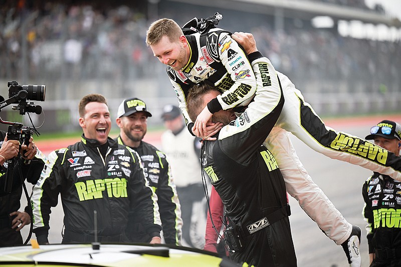 William Byron is picked up by crew member Landon Walker in celebration of his win Sunday in the NASCAR Cup Series race at Circuit of the Americas in Austin, Texas. (Associated Press)