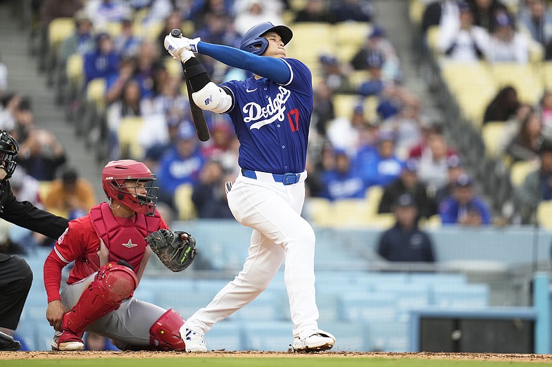 Dodgers designated hitter Shohei Ohtani swings at a pitch during Sunday's exhibition game against the Angels in Los Angeles. (Associated Press)