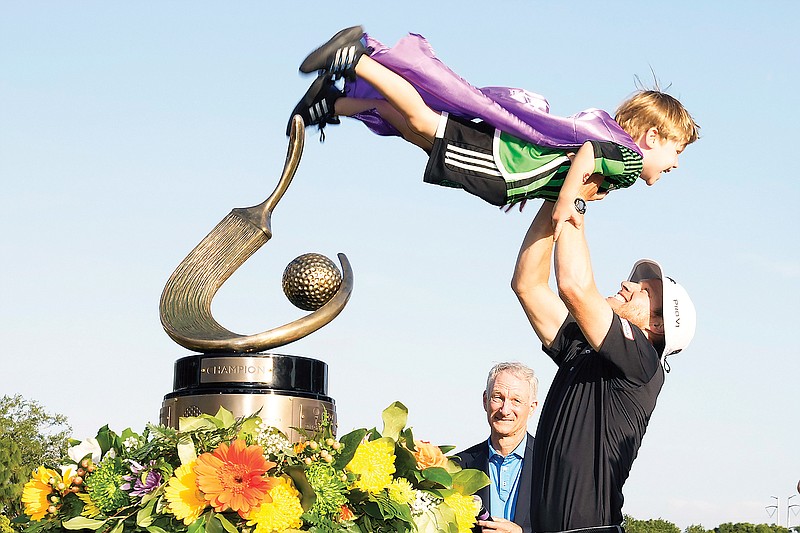 Peter Malnati lifts his son, Hatcher, after winning the Valspar Championship on Sunday in Palm Harbor, Fla. (Associated Press)