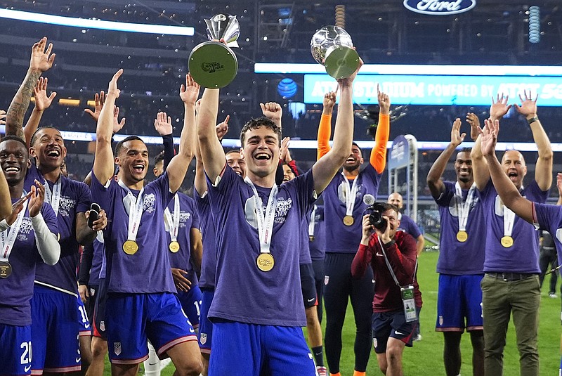 United States forward Gio Reyna (center) and his teammates celebrate after a win against Mexico in a CONCACAF Nations League final Sunday in Arlington, Texas. (Associated Press)