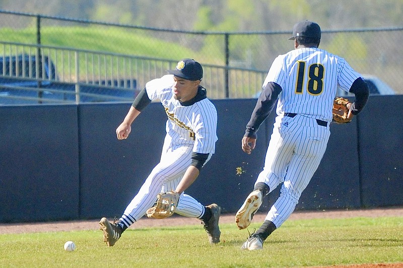 UAPB junior third baseman Jaylon Nauden fields a ground ball as junior lefthanded pitcher Darries Boyd looks on during Tuesday's baseball game against Arkansas State at the Torii Hunter Baseball Complex in Pine Bluff. (Special to the Commercial/William Harvey)