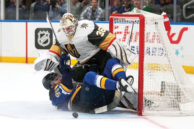 Pavel Buchnevich of the Blues slides into Golden Knights goaltender Logan Thompson during overtime in Monday night’s game at Enterprise Center in St. Louis. (Associated Press)