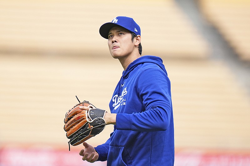 Shohei Ohtani of the Dodgers warms up before Monday night’s exhibition game against the Angels in Los Angeles. (Associated Press)