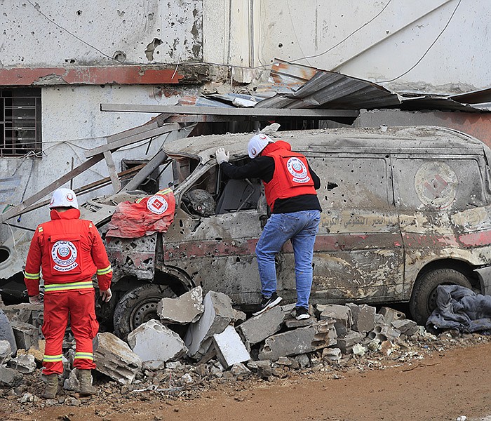 Paramedic workers check a damaged ambulance parked outside of a paramedic center that was destroyed by an Israeli airstrike early Wednesday in Hebbariye village, south Lebanon. More photos at arkansasonline.com/gazaweek25/.
(AP/Mohammed Zaatari)
