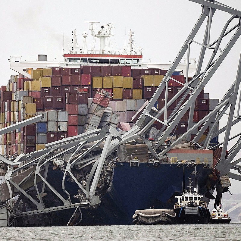 The cargo ship Dali sits under part of the Francis Scott Key Bridge on Wednesday after the ship hit the bridge in Baltimore.
(AP/Steve Helber)