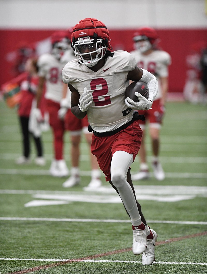 Arkansas receiver Andrew Armstrong carries the ball Tuesday, March 26, 2024, after making a catch during practice inside the Pat and Willard Walker Pavilion on the university campus in Fayetteville. Visit nwaonline.com/photo for today's photo gallery..(NWA Democrat-Gazette/Andy Shupe)
