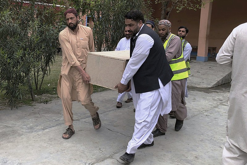 Volunteers carry a casket of a Chinese national, who was killed in the suicide bombing, at a hospital in Basham, in Shangla District in the Pakistan’s Khyber Pakhtunkhwa province on Tuesday.
(AP)