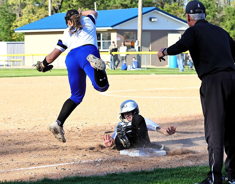 Smackover's Alyssa Hubbard slides safely into third as Parkers Chapel's Krista Rivers leaps to catch the throw Tuesday at Swilley Field.