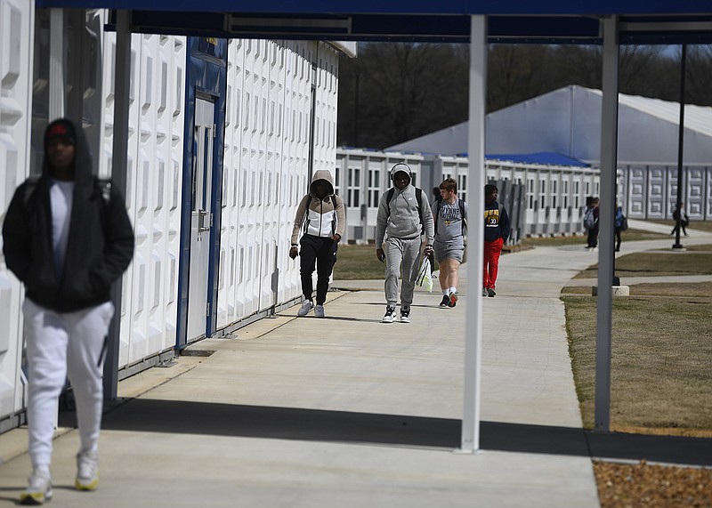 Students walk through the temporary campus of Wynne High School earlier this month. The campus is being used while a permanent replacement is built for the school after it was destroyed by a tornado on March 31, 2023. More photos at arkansasonline.com/329wynneanniv/.
(Arkansas Democrat-Gazette/Stephen Swofford)