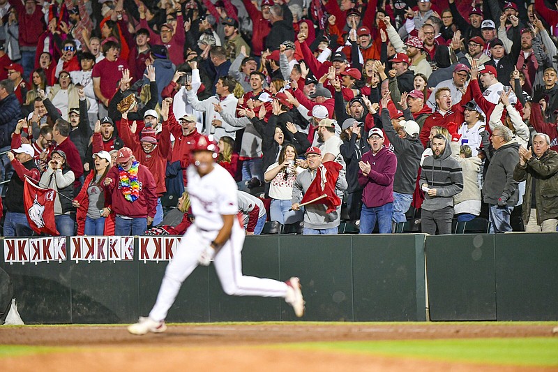Arkansas fans cheer Thursday as right fielder Kendall Diggs rounds the bases after hitting a three-run home run in the eighth inning of the top-ranked Razorbacks’ 7-4 victory over the No. 7 LSU Tigers at Baum-Walker Stadium in Fayetteville. More photos at nwaonline.com/329lsuua/.
(NWA Democrat-Gazette/Hank Layton)