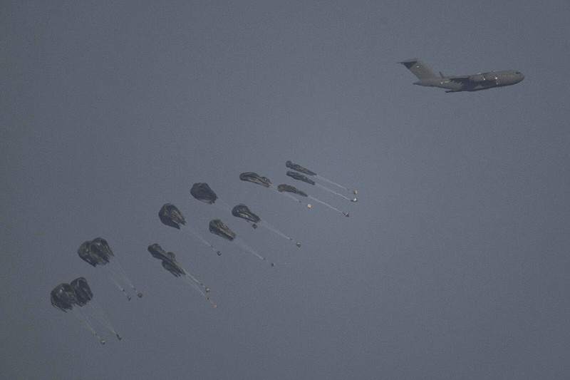 An aircraft airdrops humanitarian aid over northern Gaza Strip, as seen from southern Israel on Thursday.
(AP/Leo Correa)
