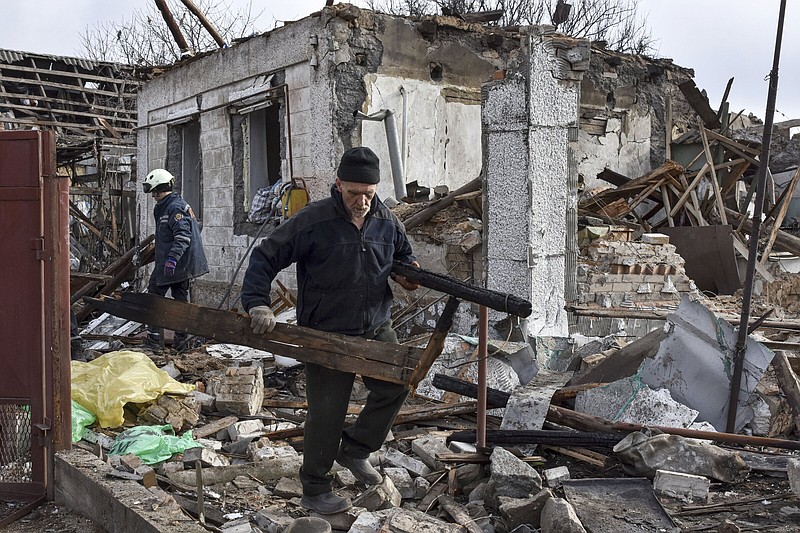A local man clears the rubble of the destroyed house of his neighbor after a Russian drone attack in Zaporizhzhia, Ukraine, on Thursday.
(AP/Andriy Andriyenko)