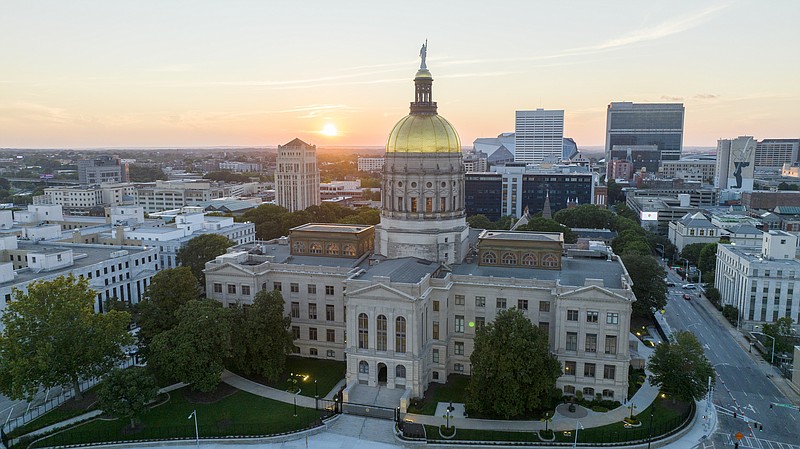 FILE - The sun sets behind the gold dome of the Georgia State Capitol in Atlanta, Aug. 28, 2022. Georgia state lawmakers are meeting for the last day of the 2024 legislative session on Thursday, March 28, 2024. (AP Photo/Steve Helber, File)