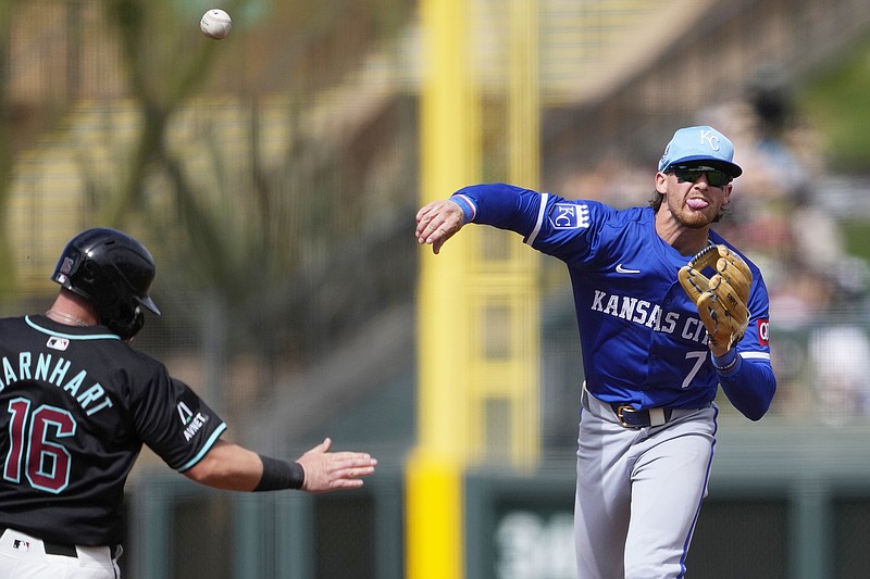 Royals shortstop Bobby Witt Jr. throws past Tucker Barnhardt of the Diamondbacks to complete a double play during a spring training game earlier this month in Scottsdale, Ariz. (Associated Press)