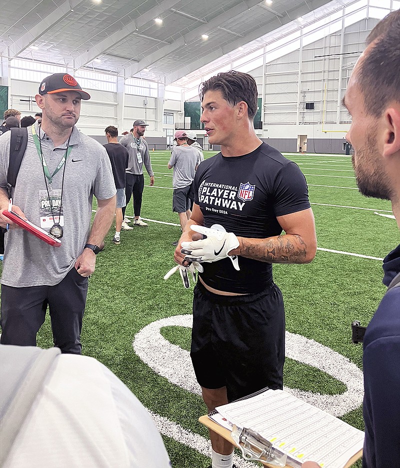 Welsh rugby star Louis Rees-Zammit speaks to NFL scouts following pro day for NFL International Player Pathway prospects last Wednesday in Tampa, Fla. (Associated Press)