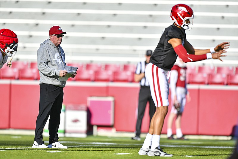 Arkansas offensive coordinator Bobby Petrino (center) looks on as quarterback Taylen Green (10) prepares to take a shotgun snap, Saturday, March 30, 2024, during a spring practice at Donald W. Reynolds Razorback Stadium in Fayetteville. Visit nwaonline.com/photo for today's photo gallery..(NWA Democrat-Gazette/Hank Layton)