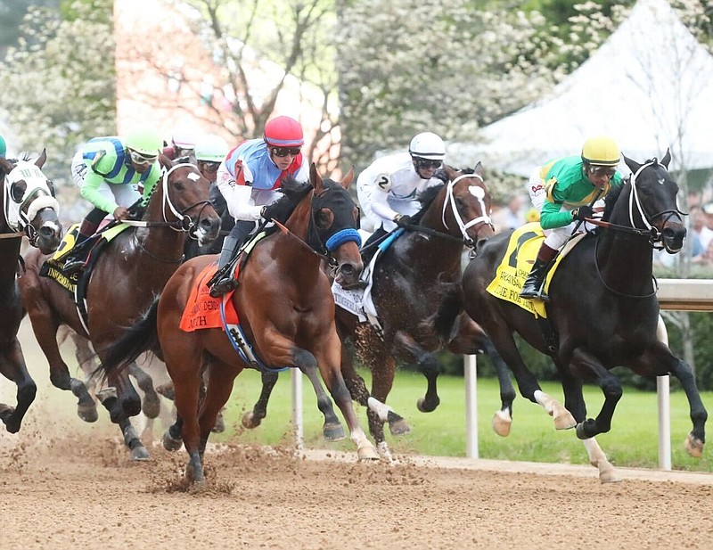 Muth (7 orange saddlecloth), ridden by Juan Hernandez, races to a first-place finish in the Grade 1, $1.5 million Arkansas Derby Saturday, defeating Just Steel (8) by two lengths. (Submitted photo courtesy of Coady Photography)
