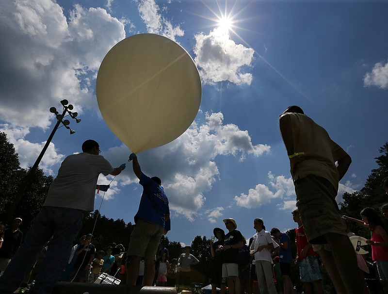 Georgia Tech professor Morris B. Cohen (right) looks on as engineering students prepare to launch a balloon to 100,000 feet. Cohen conducted an experiment during the 2017 total eclipse at a Rabun County summer camp called Ramah Darom. / Curtis Compton/ccompton@ajc.ccom