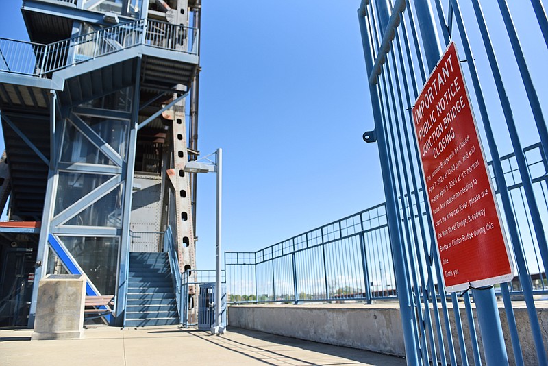 A notice posted to the gate of the Little Rock side of the Junction Bridge informs visitors that the bridge will be closed April 7 at 10 p.m. and re-open April 9 at its normal hours..(Arkansas Democrat-Gazette/Staci Vandagriff)