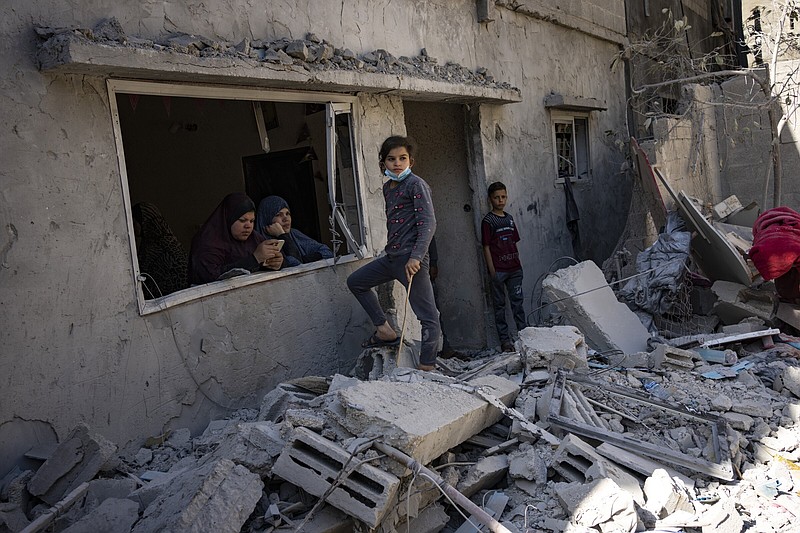 Members of the Abu Draz family inspect their house Thursday after it was hit by an Israeli airstrike in Rafah, southern Gaza Strip.
(AP/Fatima Shbair)