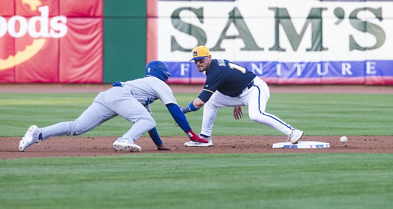 Tulsa's Jose Ramos gets back to second base while Naturals Michael Massey misses the throw Friday April 5, 2024 at Arvest Ballpark in Springdale. It was the season-opener for the Naturals. Visit nwaonline.com/photo for today's photo gallery. (NWA Democrat-Gazette/J.T. Wampler).