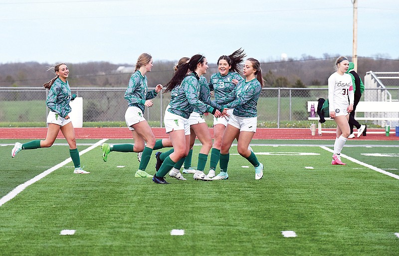 The Blair Oaks Lady Falcons celebrate after scoring a goal during Thursday night's game against the School of the Osage Lady Indians at the Falcon Athletic Complex in Wardsville. (Cleo Norman/News Tribune)