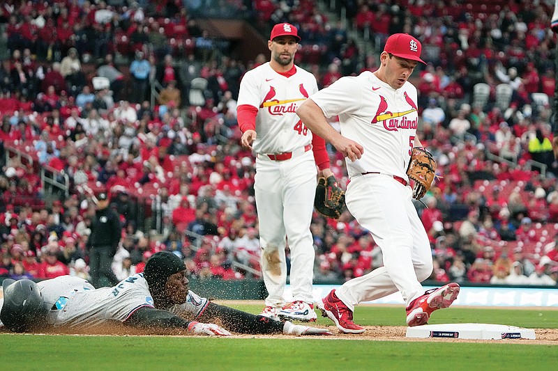 Jazz Chisholm Jr. of the Marlins is out at first base after being beaten to the base by Cardinals relief pitcher Andre Pallante as first baseman Paul Goldschmidt watches during the seventh inning of Thursday’s game at Busch Stadium in St. Louis. (Associated Press)