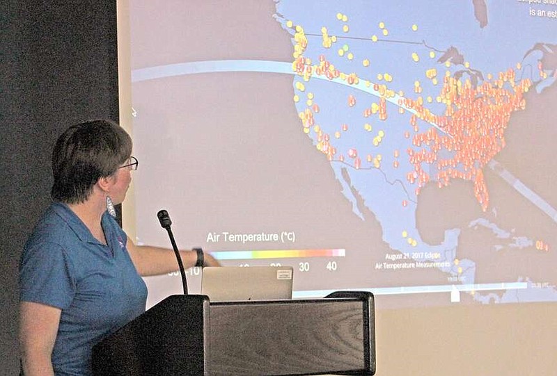Kristen Weaver, the deputy coordinator of NASA’s Global Learning and Observations to Benefit the Environment (GLOBE) Observer program, points out some of the temperature changes observed during the 2017 total solar eclipse during a presentation at the Garland County Library in Hot Springs on Thursday, April 4, 2024. (The Sentinel-Record/James Leigh)